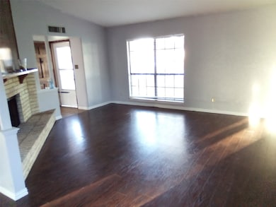 Living room with wood-style flooring and fireplace