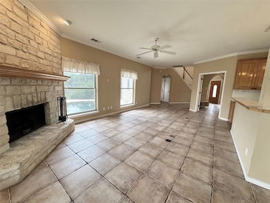 Unfurnished living room featuring arched walkways