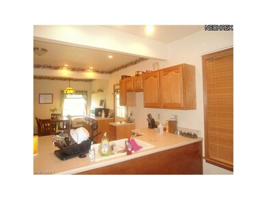 Kitchen with open view of living room and dining a