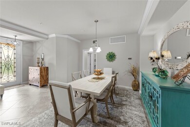 Dining area with a chandelier, crown molding, and tile floors