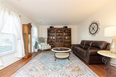 Living area with baseboards, wood finished floors,