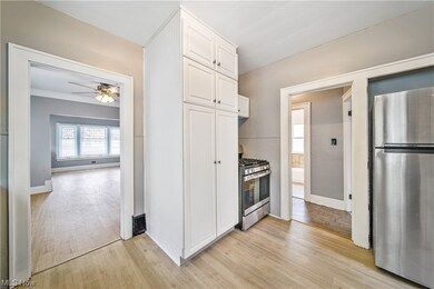 Kitchen featuring ceiling fan, light hardwood flooring, white cabinetry, and appliances with stainless steel finishes