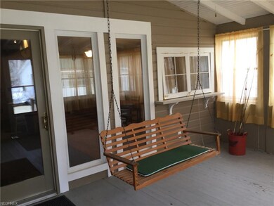 Relax on the swing in the sunroom/enclosed porch