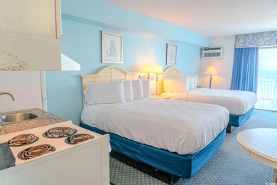 Carpeted bedroom featuring a sink and a wall mounted AC