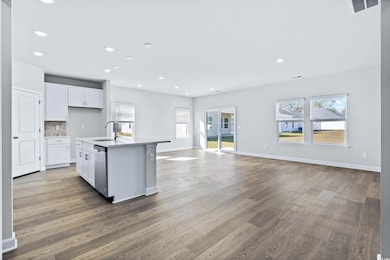 Kitchen featuring sink, dishwasher, an island with