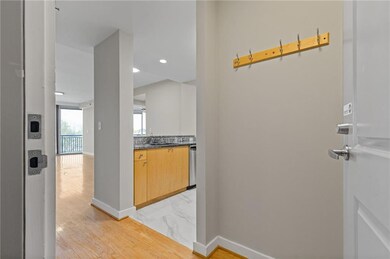 Hallway featuring light marble finish flooring and recessed lighting