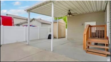 View of patio / terrace featuring a storage shed and a ceiling fan