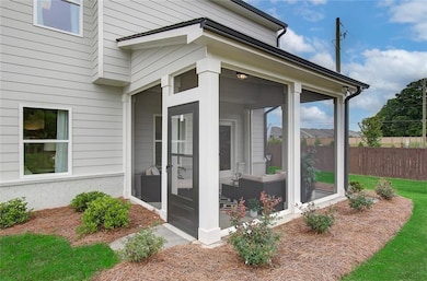View of exterior entry featuring fence