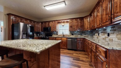 This Chef's Kitchen is freshly remodeled and extremely spacious.  The Luxury Vinyl Plank flooring, Granite counters, and ample cabinetry shine, and the Stone Backsplash needs to be seen in person!