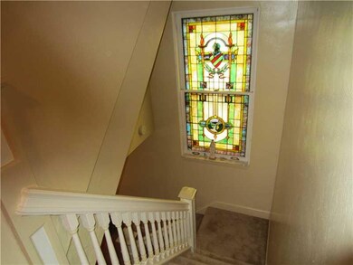 Living Room. Beautiful stained window in stairway 