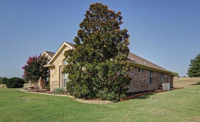 View of side of home featuring central AC and a yard