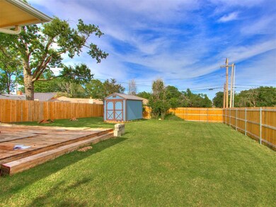 View of yard with a deck and a storage shed