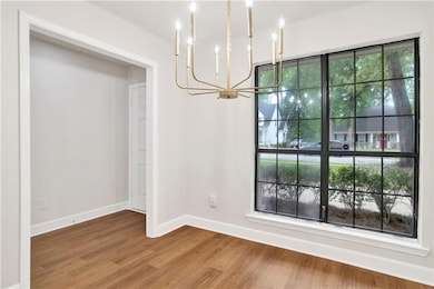 Unfurnished dining area with an inviting chandelie