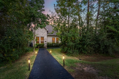 Thoughtfully planned landscaping with magnolias, hollies, ligustrum and flowering shrubs enhances privacy and curb appeal.