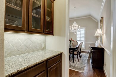 The Butler Pantry is situated between the Kitchen and Formal Dining room with glass cabinets and under cabinet lighting.