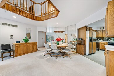 Dining Room open to living room, mirrored wall.