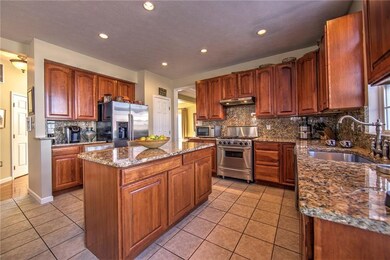 Eat-in kitchen with granite, commercial stove...
