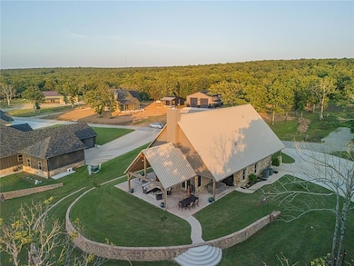 Aerial view of property and surrounding area featuring a heavily wooded area