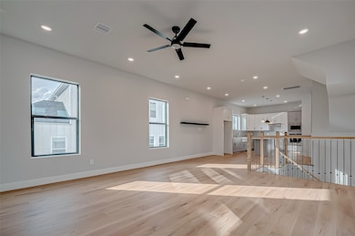 A spacious, open-concept living area with hardwood