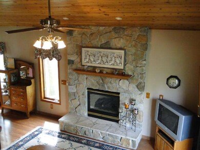 Family room addition with Stone fireplace and knot