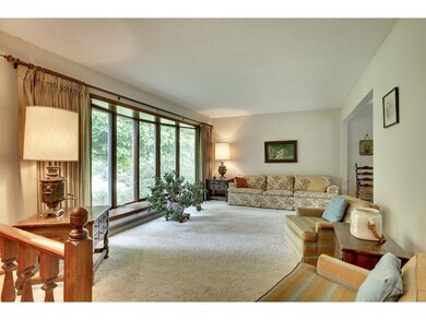 The living room welcomes you with a large bay wind
