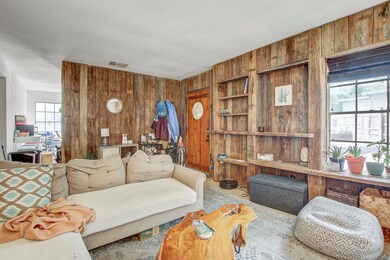 Living room with wood walls and carpet flooring
