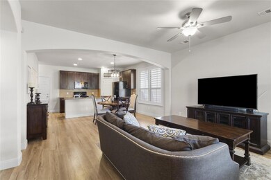 Living area with arched walkways, light wood-styl