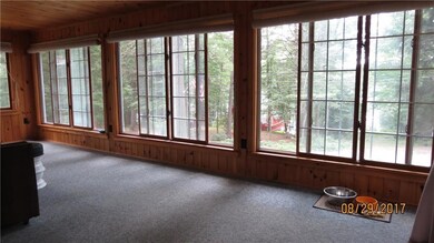 Large enclosed porch with views of...
