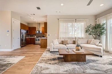 Living room with track lighting, light wood-style