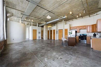 Garage featuring stainless steel refrigerator with ice dispenser and a sink