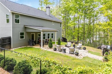 Rear view of property with a fenced backyard, a ch