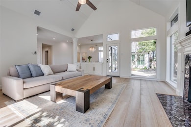 Living area featuring high vaulted ceiling, a ceil