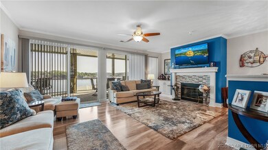 The spacious living room features a fireplace and big lake views!
