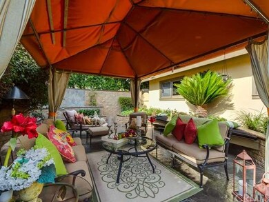 The colorful front patio is highlighted by the per