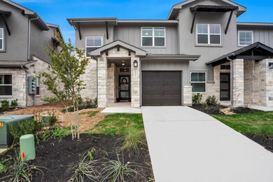 View of front of house with stone siding, an atta