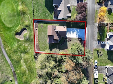 Drone shot of the home, approximate property lines and location near lovely trees and the golf course.