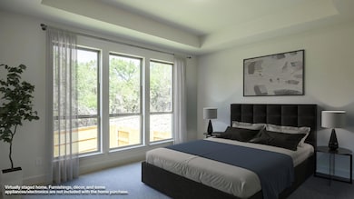 Bedroom featuring a tray ceiling, carpet flooring
