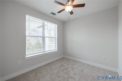 Empty room featuring light carpet and ceiling fan