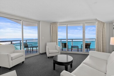 Living room with carpet, expansive windows, and a 