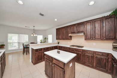 This spacious kitchen features dark wood cabinets