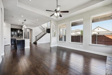 Unfurnished living room featuring a raised ceiling