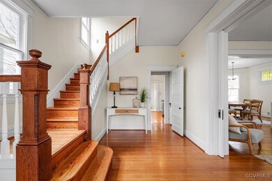 Stairway with wood finished floors, baseboards, a