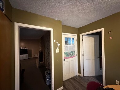 Hall with hardwood / wood-style flooring and a tex