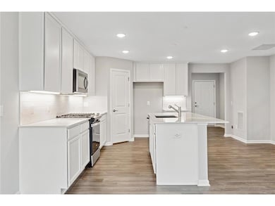 The kitchen has great cabinet space, as shown in another Hampton. Colors and design features may vary.