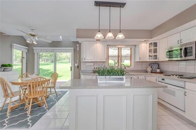 Sliding glass doors to the large wooden deck overl