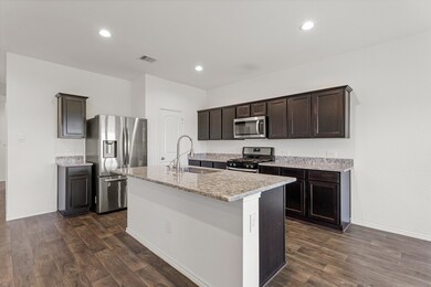 This spacious kitchen features high ceilings, dark