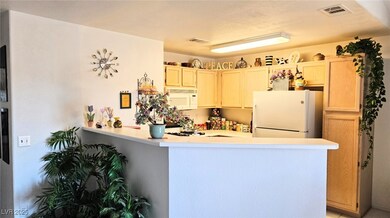 Kitchen featuring white appliances, a peninsula, a