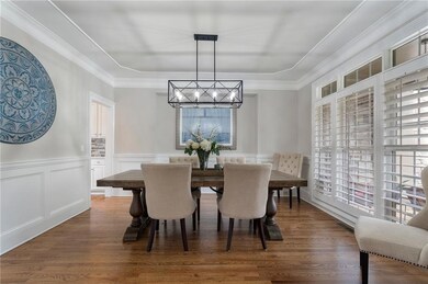 Dining space featuring a decorative wall, an invit