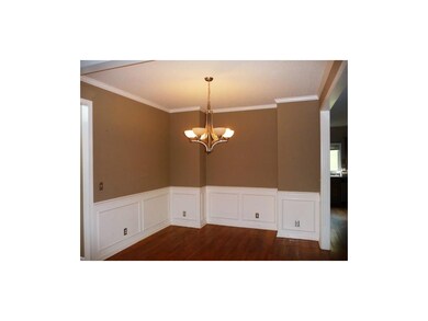 Formal dining room has hardwood floors.