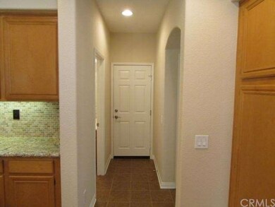 The kitchen leads to the powder room to the left, 